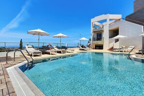 Seasonal outdoor pool, pool umbrellas, pool loungers