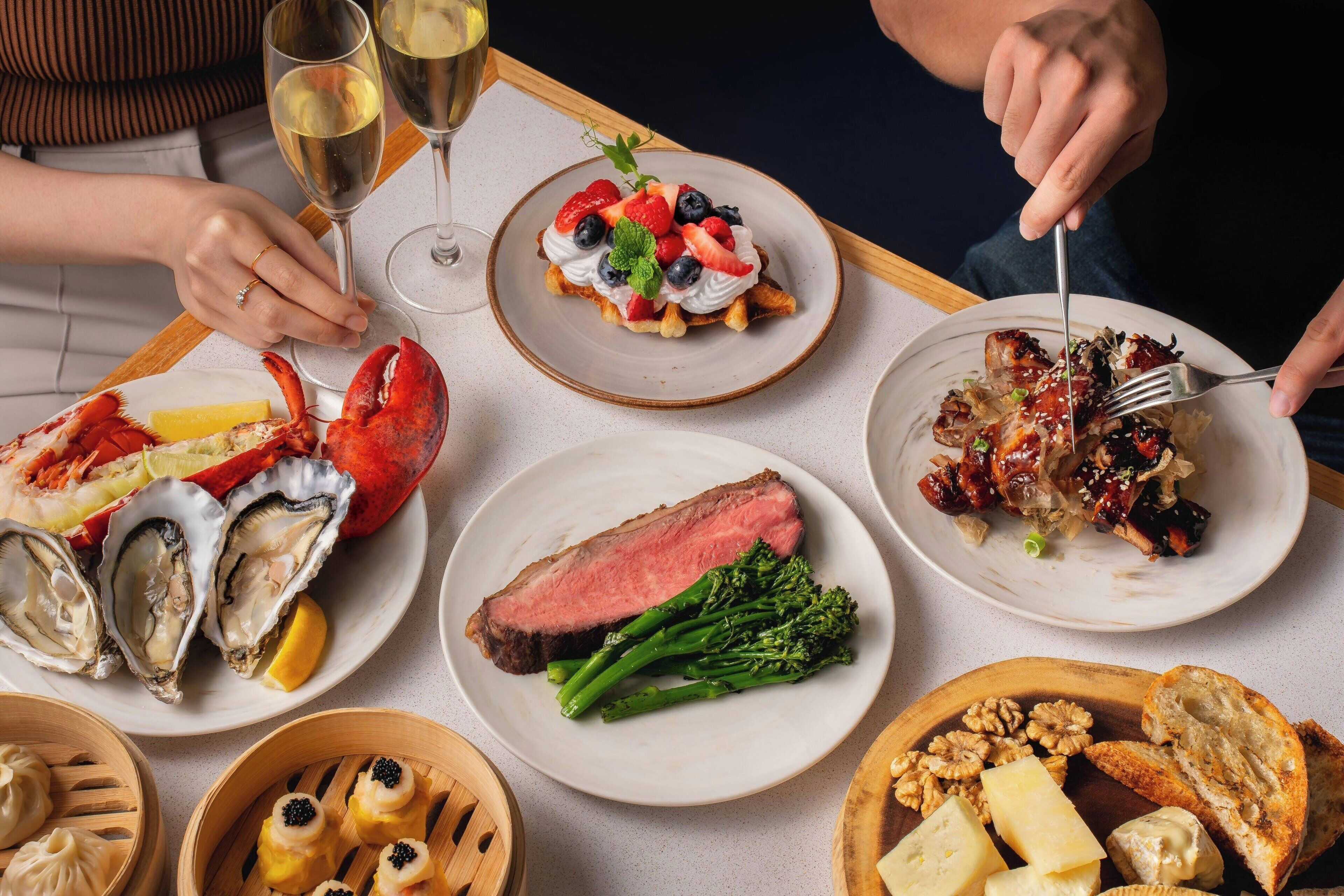 A dining table with various dishes including seafood, steak, and vegetables.