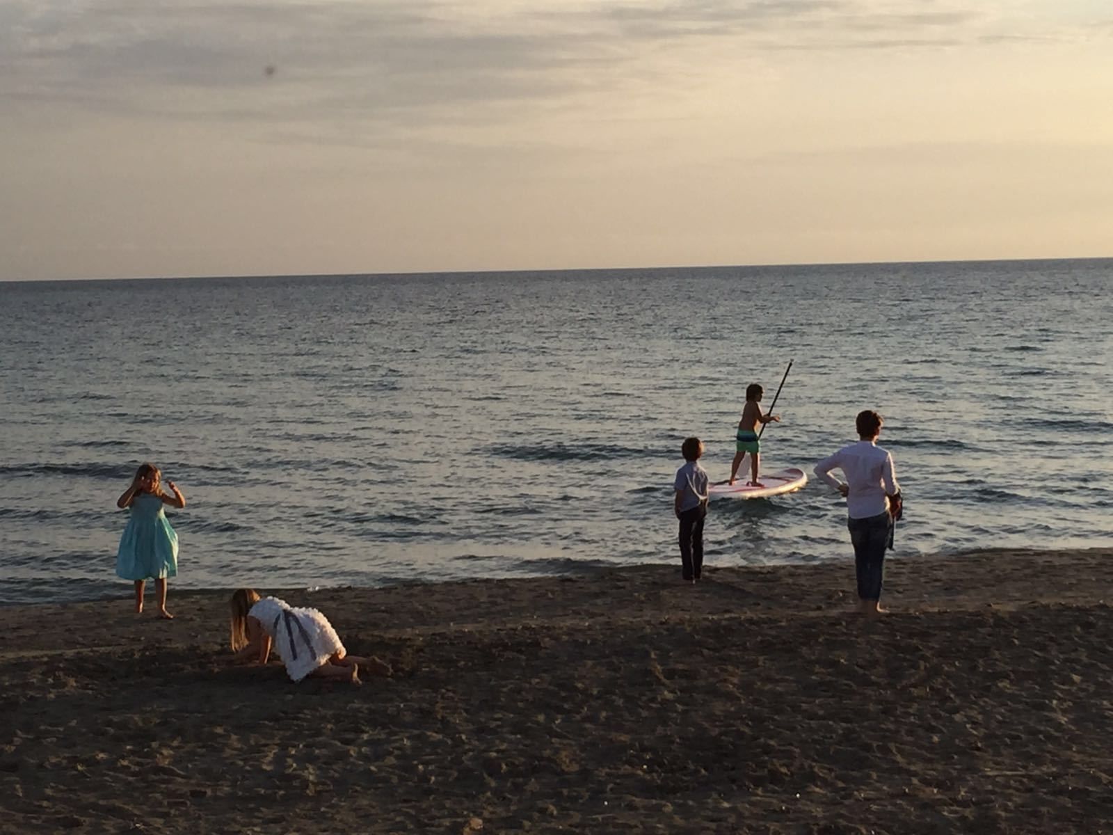 A beach scene with people engaging in water activities.