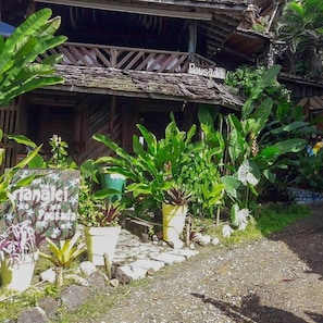 A rustic wooden building with a sign that reads "Pousada."