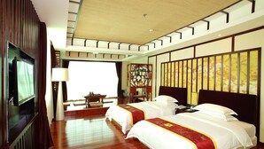 A hotel room with two beds, a TV, a desk, and a large window. - Guangdong Jin Bao Lai Hotel (Guangzhou)