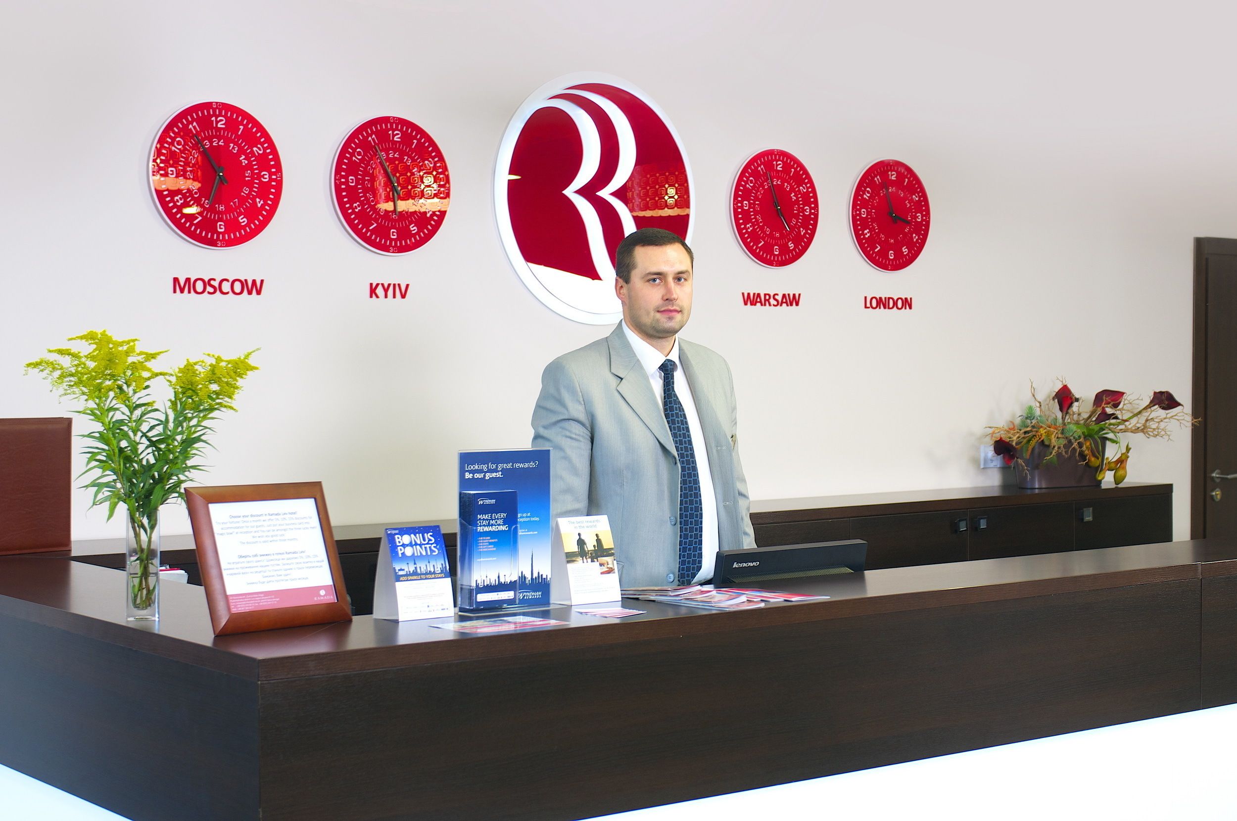 A reception desk with clocks indicating Moscow, Kyiv, Warsaw, and London.