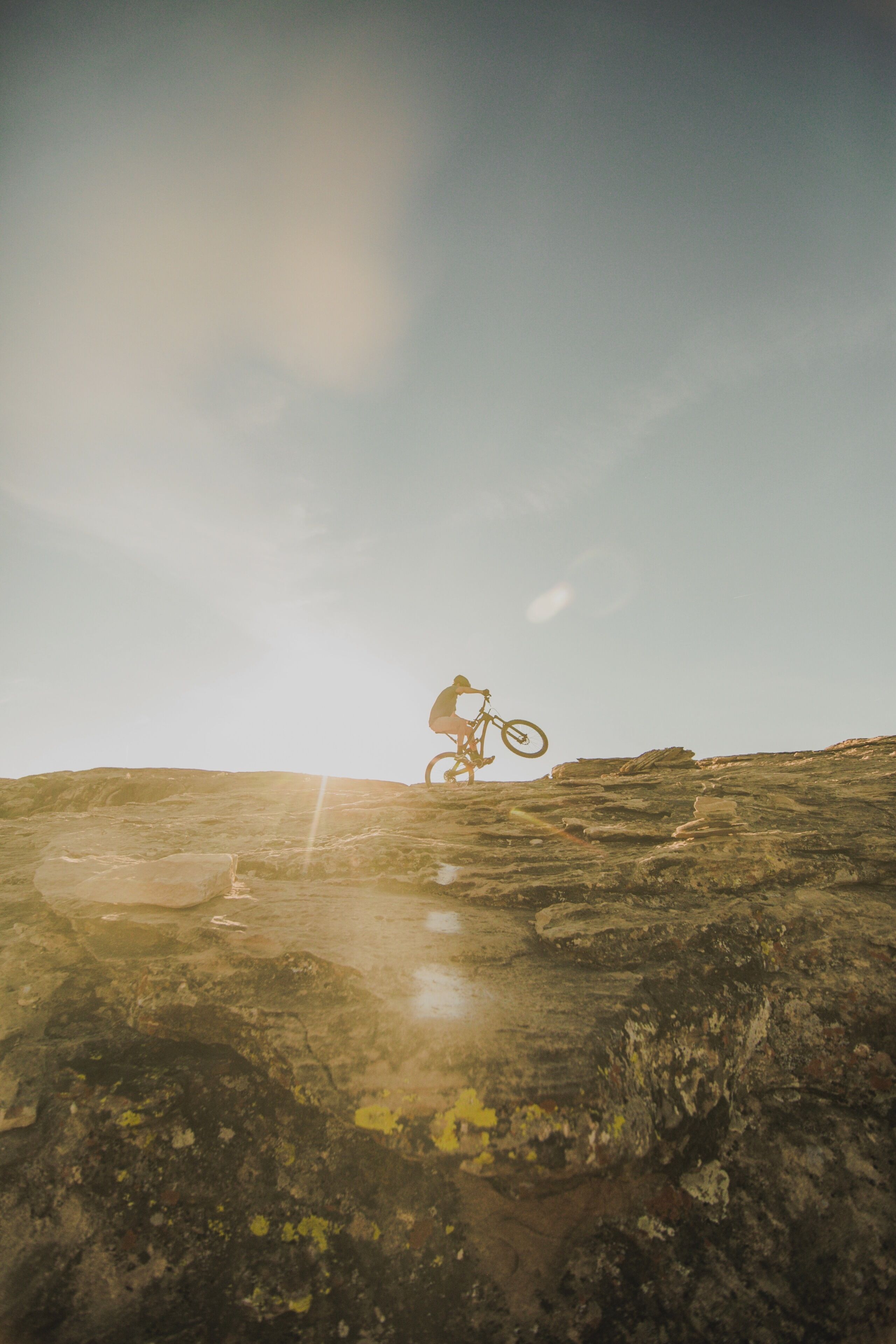 A person on a mountain bike on a rocky terrain.