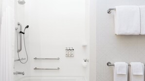 A modern bathroom with a bathtub, shower, and towel rack. - Holiday Inn Express & Suites Oak Ridge by IHG (Oak Ridge)