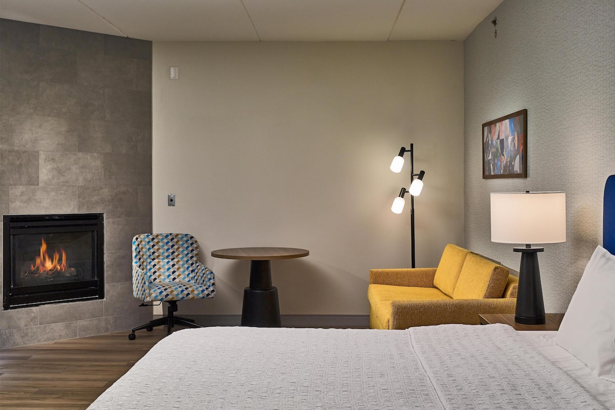 Room, 1 King Bed with Sofa bed, Fireplace | Living area | 55-inch flat-screen TV with cable channels, TV