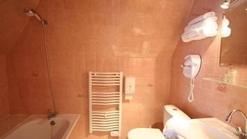 A bathroom with a bathtub, toilet, and sink. There is a towel rack and a mirror.