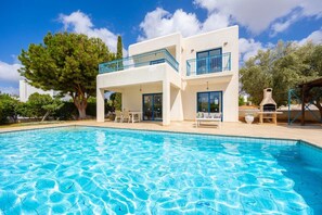 A modern two-story house with a swimming pool, outdoor seating, and a barbecue area. - Azzurro Luxury Holiday Villas (Pegeia)