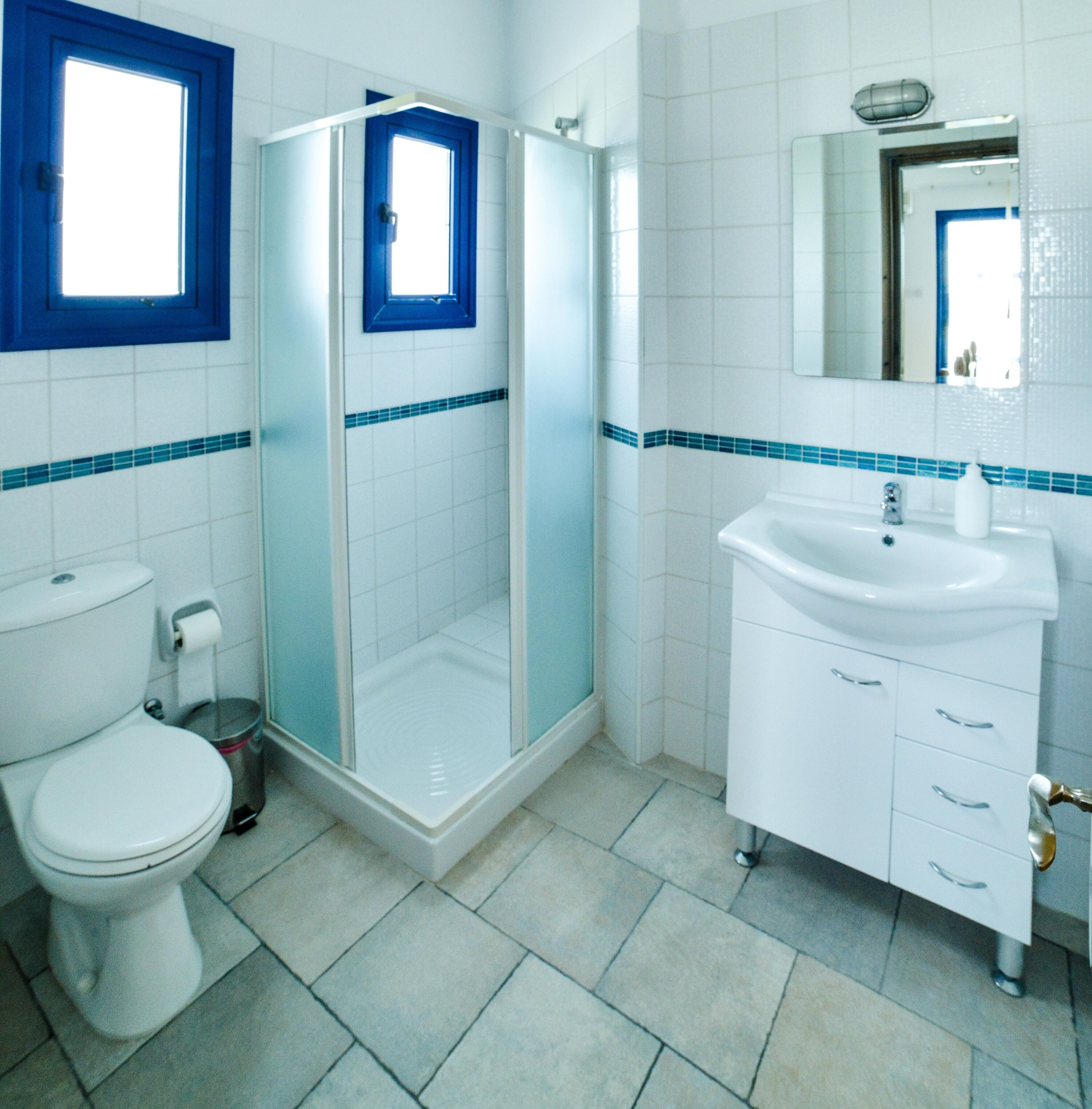 A bathroom with a toilet, a sink, and a shower.