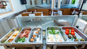 A buffet with various food options including meats, eggs, and vegetables. - Fitos Inn Guest House (Geroskipou)