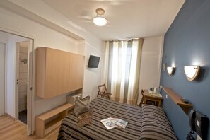 A bedroom with a bed, a TV mounted on the wall, a desk with a chair, and a phone on the bedside table. - Hotel De La Porte Saint Pierre (Saint-Malo)