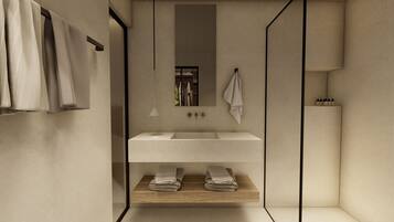 Un baño moderno con lavamanos blanco, estante de madera y toallas colgando.