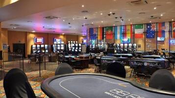 Experience the excitement of gaming at our casino, featuring electronic machines and comfortable seating.