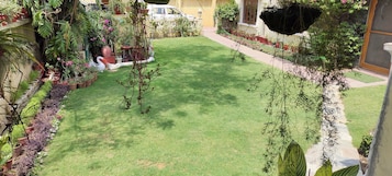 A well-maintained garden with a variety of potted plants and a neatly trimmed lawn.