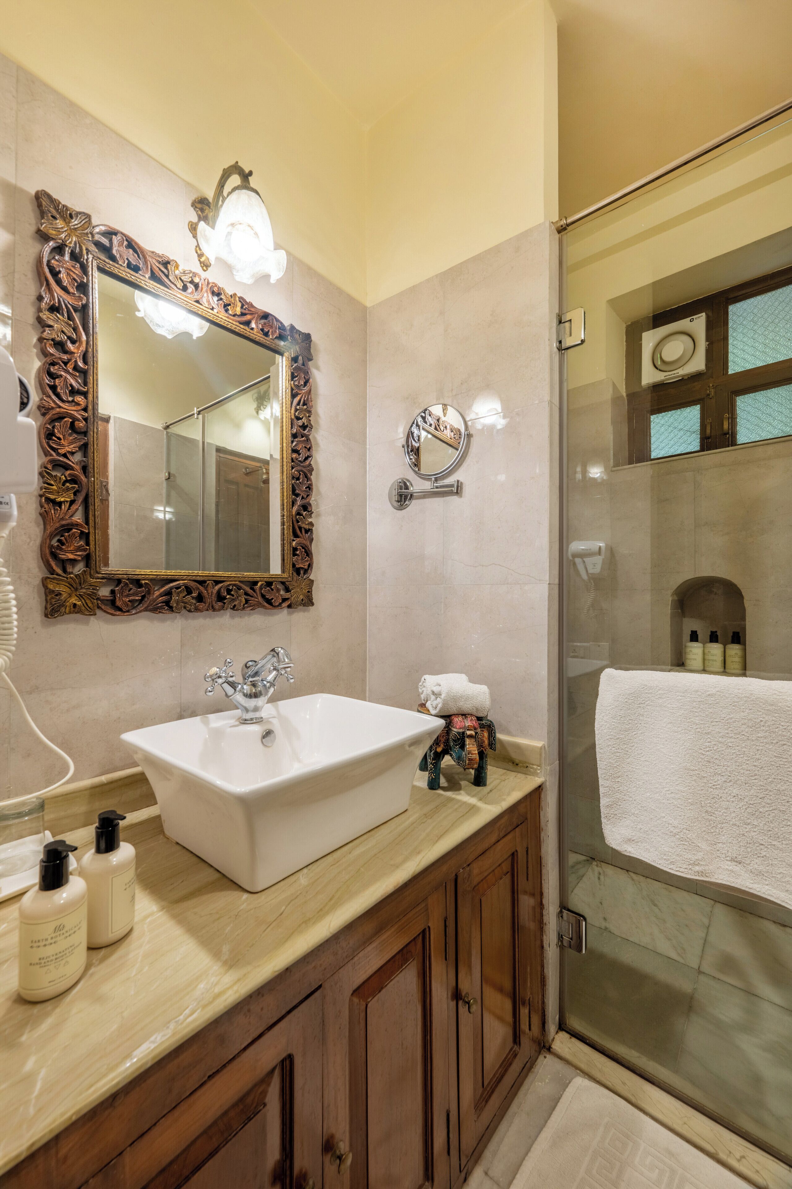 deluxe room with complimentary airport pick up | bathroom | designer toiletries, hair dryer, slippers, bidet