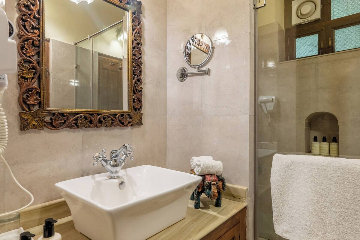 deluxe room with complimentary airport pick up | bathroom | designer toiletries, hair dryer, slippers, bidet