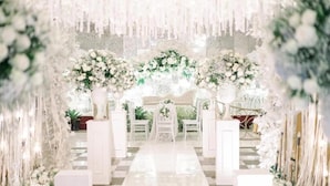 A white, ornate archway with floral decorations and a checkered floor leading to a seating area. - The Grand Palace Hotel Malang (Malang)