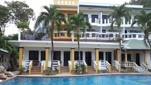 A two-story building with a swimming pool in front. - Seashore Beach Resort (Puerto Galera)