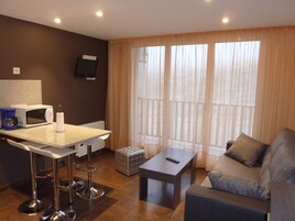 Superior Studio 4 guests | Living room | 36-inch flat-screen TV with digital channels, TV