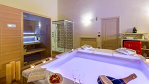 A spa area with a large soaking tub, a wooden cabinet, and a shower enclosure.