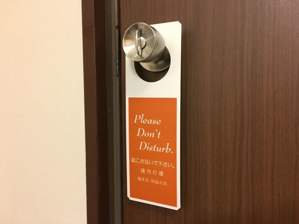 A door with a sign that reads "Please Don't Disturb."