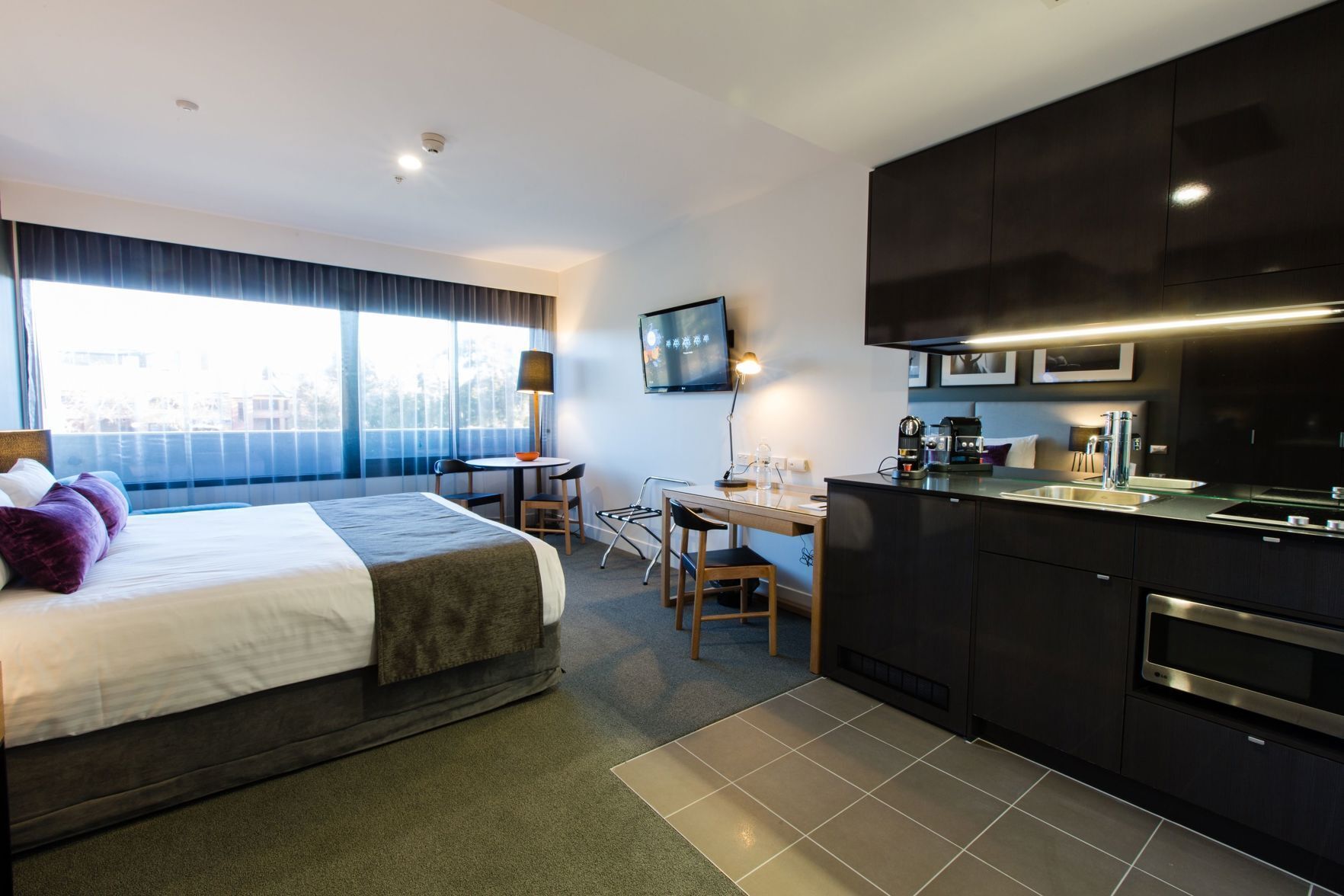 أغطية فراش متميزة وميني بار وخزنة داخل الغرفة ومكتب