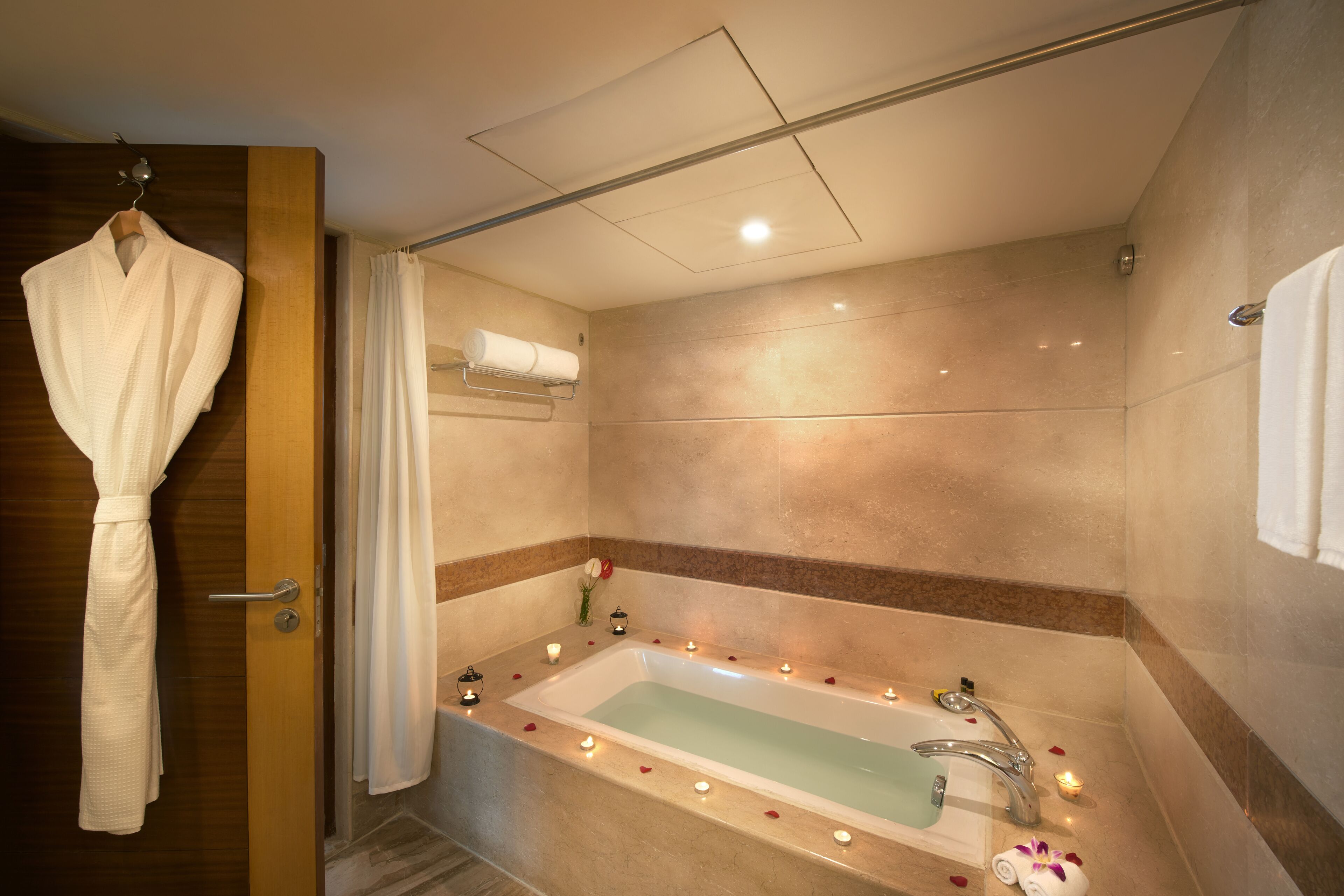 deluxe suite | bathroom | hair dryer, bathrobes, slippers, towels