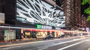 A hotel with a modern facade featuring a distinctive geometric design. - Hotel G7 Taipei (New Taipei City)