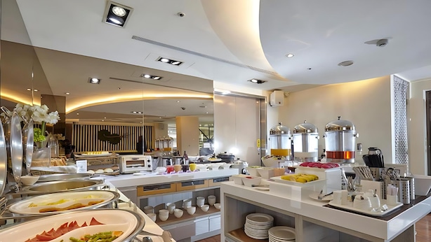A buffet setup with various food items and serving utensils. - Hotel G7 Taipei (New Taipei City)