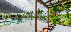 Relax by the oval-shaped pool surrounded by a tiled deck and lounge chairs.