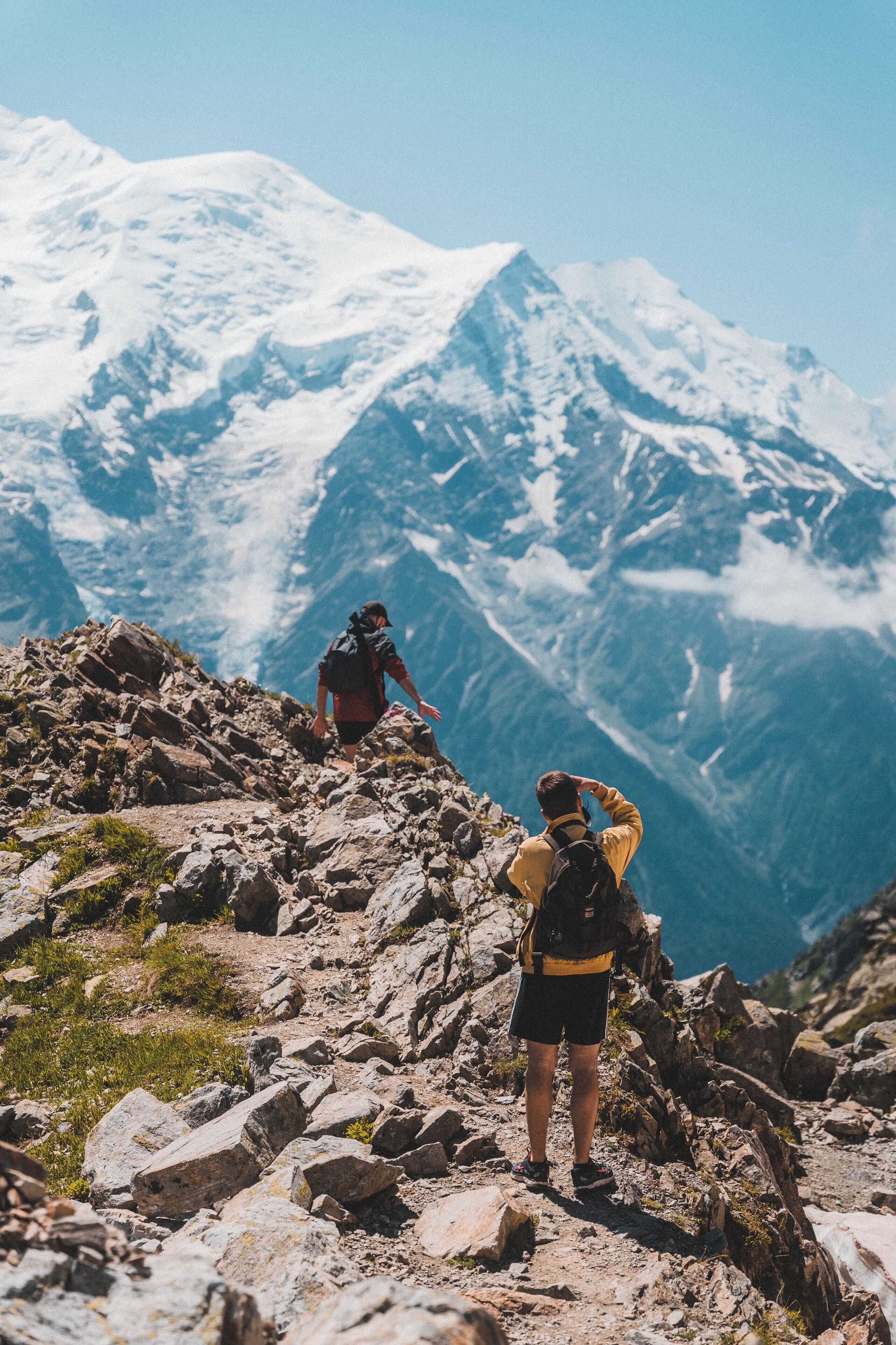 A mountainous landscape with rocky terrain and snow-capped peaks.