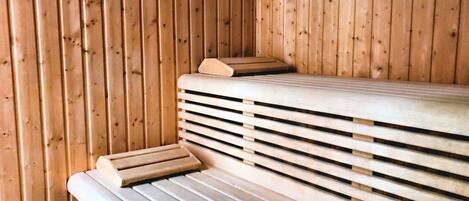 A sauna with wooden benches and a bench seat.