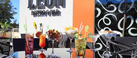 A table with various drinks and a sign for Leon Bistro Bar.