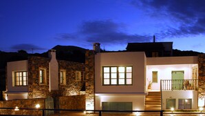 A two-story stone building with a balcony and a staircase leading to the upper floor. - Mohlos Villas (Sitia)