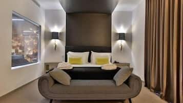 Deluxe Suite, River View | Minibar, in-room safe, desk, blackout drapes