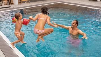 Seasonal outdoor pool, open 9:00 AM to 8:00 PM, pool umbrellas