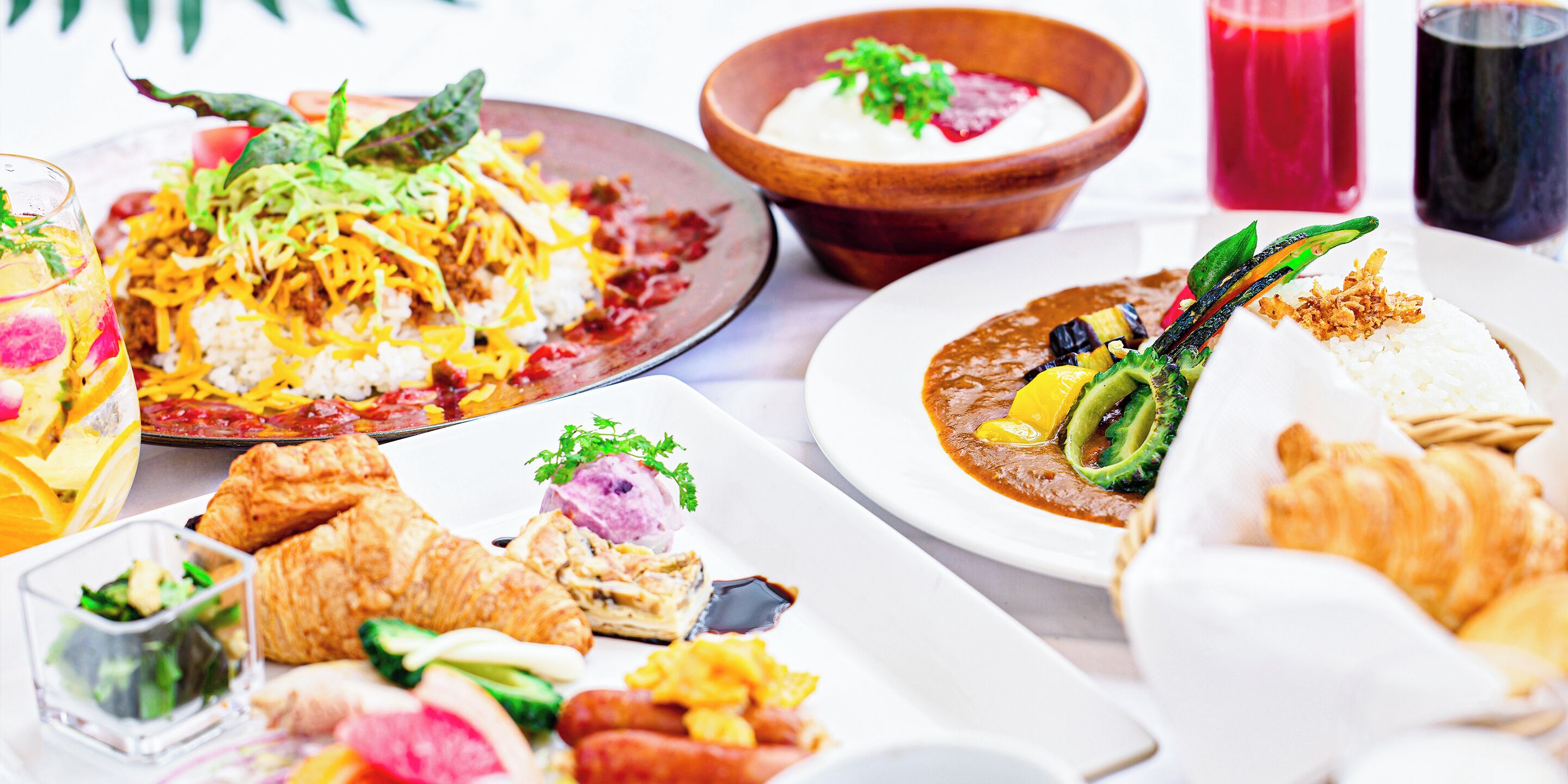 A variety of breakfast dishes including pancakes, eggs, and pastries.