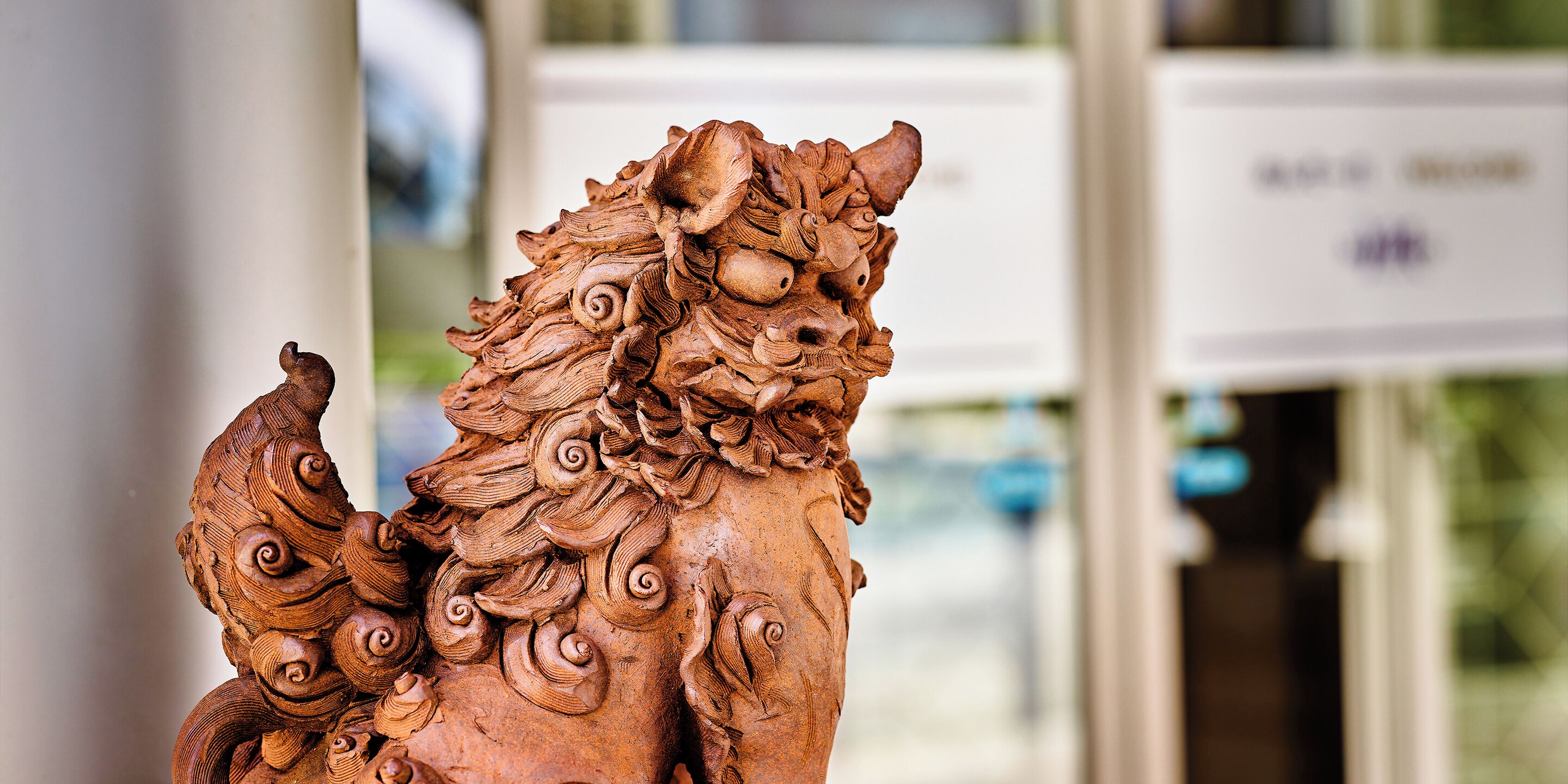 A detailed sculpture of a lion with intricate carvings.