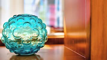 A blue glass object on a wooden surface.