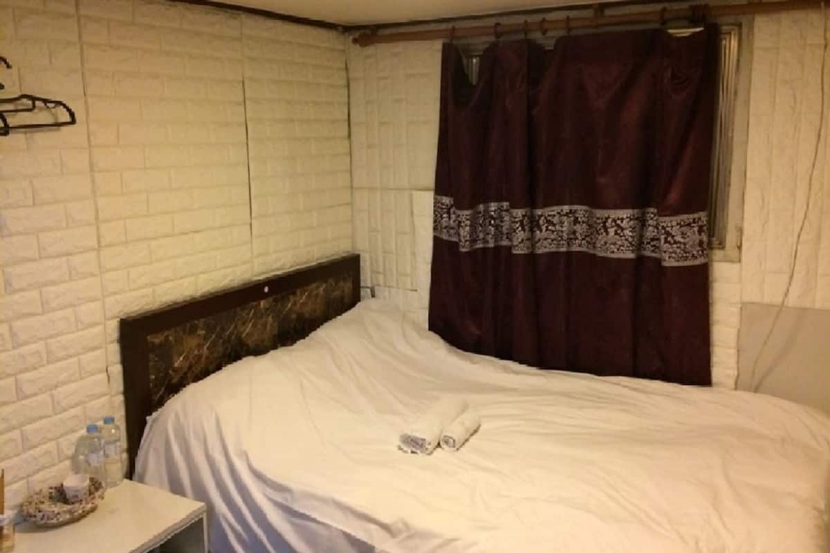 Economy Deluxe Double Room (Basement) | Down comforters, blackout drapes, WiFi (free)