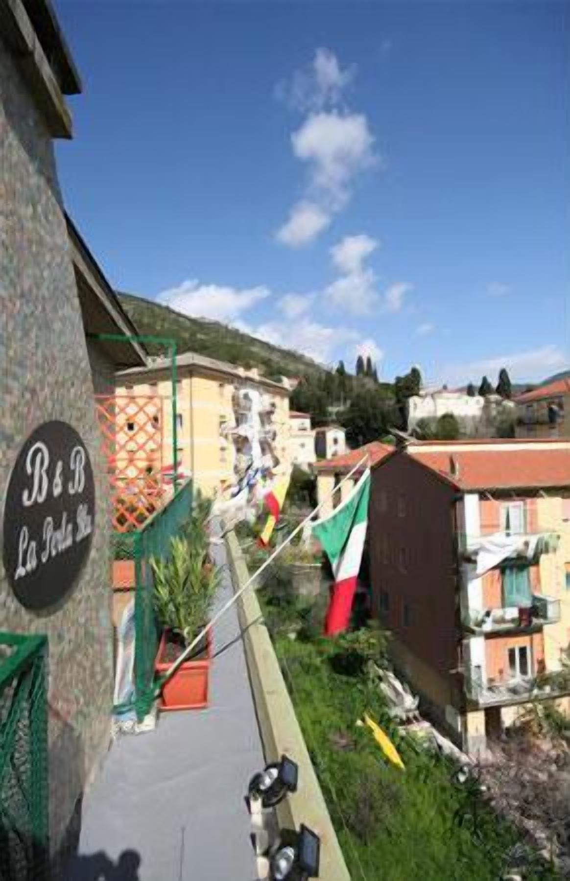 Vista de la calle con un cartel de restaurante, edificios y una bandera.
