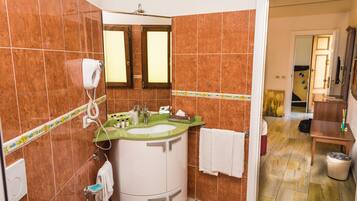 A bathroom with a sink, mirror, and towel rack.