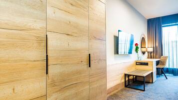 Relax in this stylish room with a large wardrobe, flat-screen TV, and comfortable desk area.