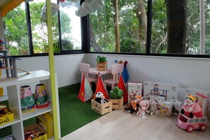 A children's play area with a table, chairs, and various toys. - Secret Cliff Villa (Karon)