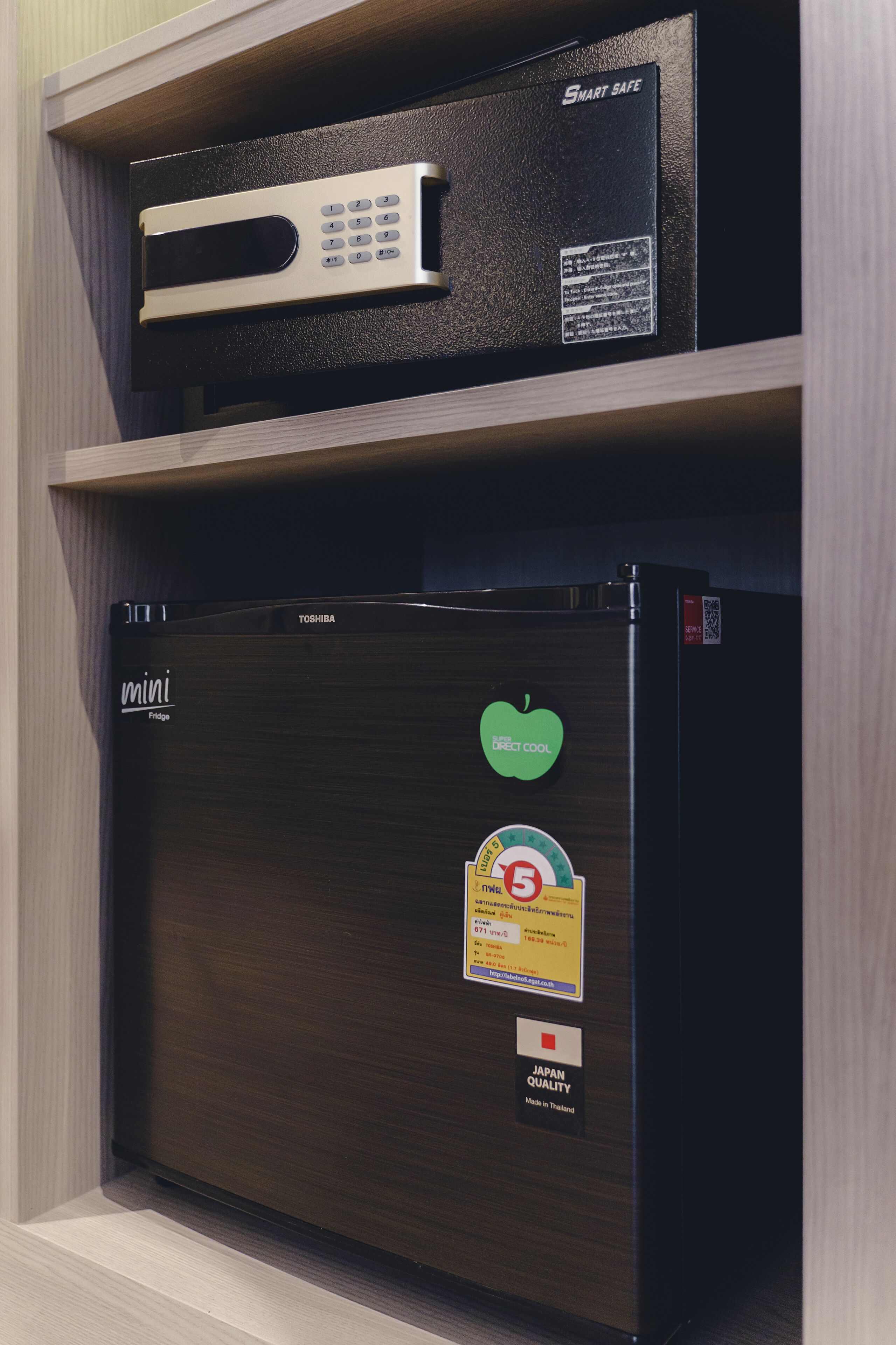 A compact refrigerator with a Toshiba logo, a mini fridge compartment, and a 'Japan Quality' sticker.