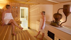 A sauna with wooden benches and a large copper heating unit. - The Headquarters Inn (Nairobi)