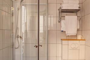 Comfort tweepersoonskamer | Badkamer | Een douche, een haardroger, handdoeken