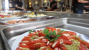 A buffet with various food options, including seafood and salads. - Hill View Restaurant & Apartments (Pissouri)