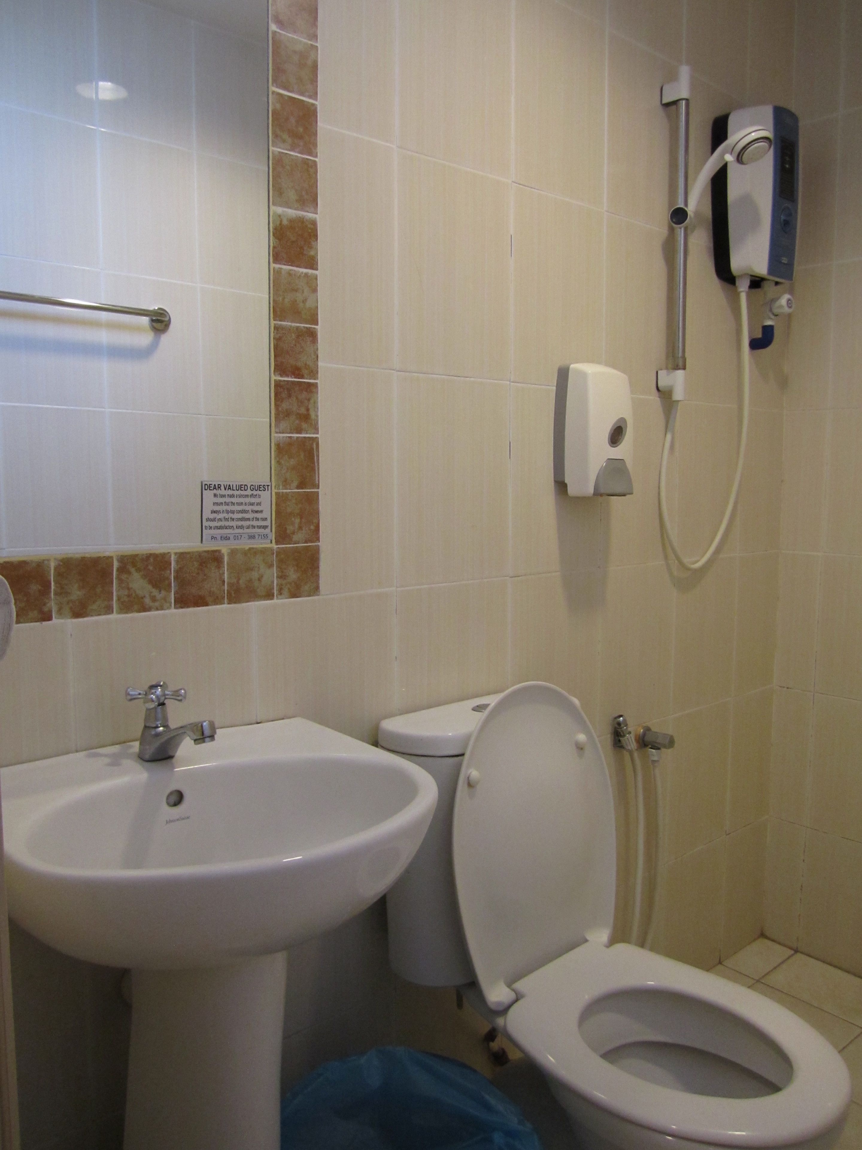 A bathroom with a sink, toilet, and shower.
