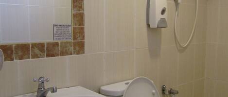 A bathroom with a sink, toilet, and shower.