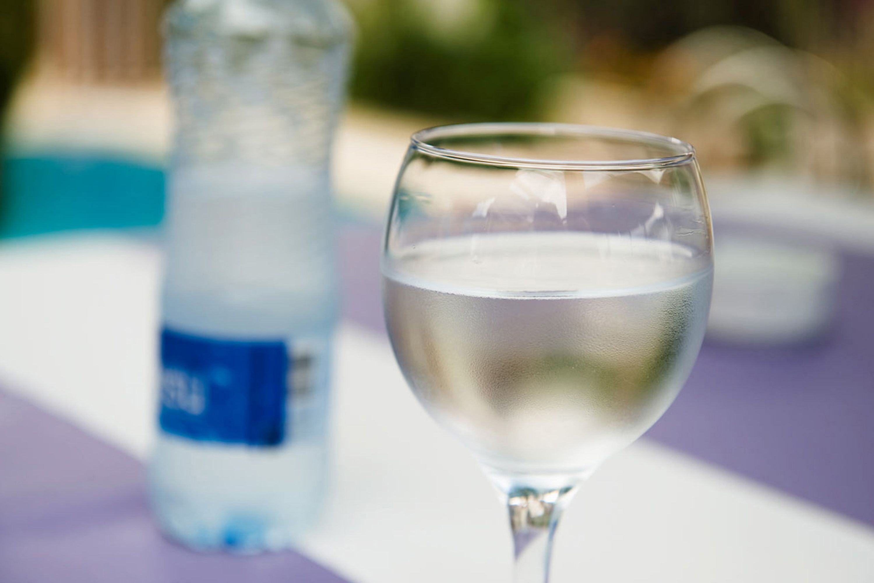 A glass of water with a blurred background.